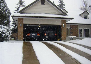 Heated driveway with dual heated tire track configuration.